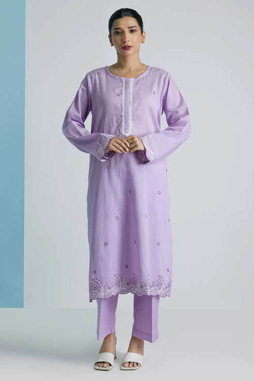 Woman wearing a light purple kurta with white embroidery on a light gray background