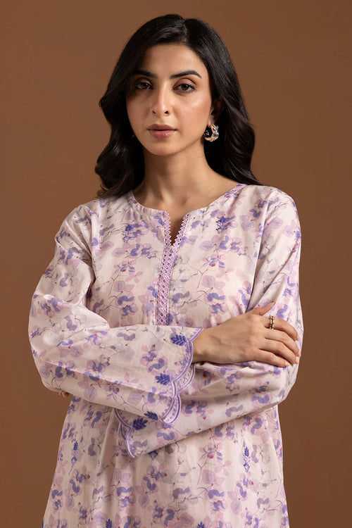 Woman wearing a floral kurta against a brown background